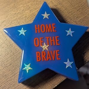 Blue Star Shaped Decor with Red Text